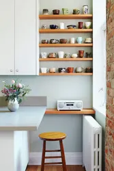 Photo of a kitchen with shelves and cabinets on the wall