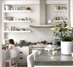 Photo of a kitchen with shelves and cabinets on the wall