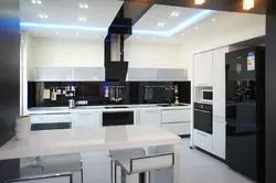 Photo of a kitchen with a black countertop and a black refrigerator