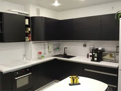 Photo Of A Kitchen With A Black Countertop And A Black Refrigerator