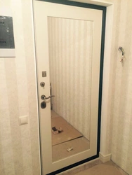 Entrance door with mirror in the hallway interior
