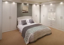 Bedroom design with large wardrobe and bed