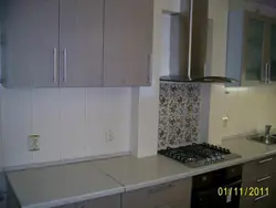 Photo of a kitchen with pipes in an apartment