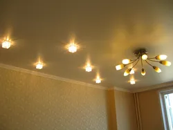 Пәтердегі қонақ бөлмесінің фотосуретіндегі жарықтандырғыштары бар аспалы төбе