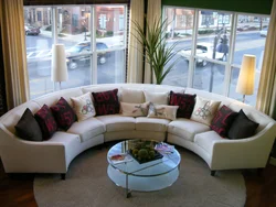 Living room with round sofa interior photo
