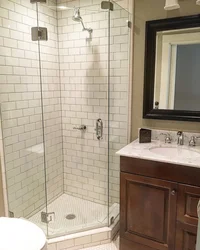 Bathtub and shower without tray in one room design