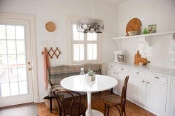Photo of a kitchen with a round table against the wall