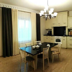 Interiors of a living room with a kitchen by the window