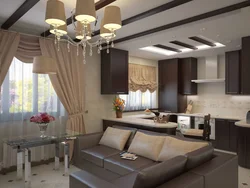 Interiors of a living room with a kitchen by the window