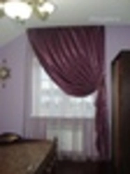 One curtain on the window in the bedroom with tulle photo