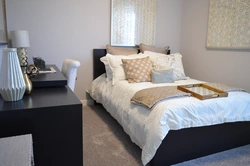 Bed along the wall in a small bedroom design