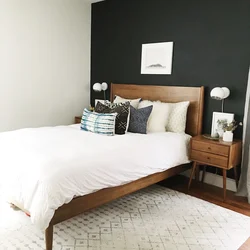 Bed along the wall in a small bedroom design