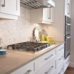 Marble countertop and splashback in a white kitchen photo