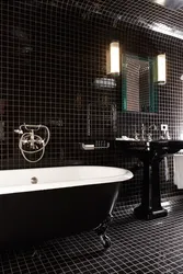 Black bathtub in the bathroom interior photo