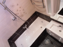Photo Of A Bathtub After Renovation With Tiles In An Apartment