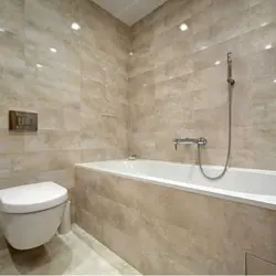 Photo of a bathtub after renovation with tiles in an apartment