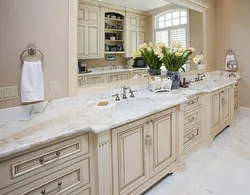 White kitchen with marble countertops in the interior photo