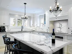 White kitchen with marble countertops in the interior photo