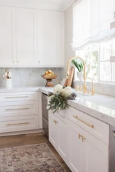 White kitchen with gold handles photo