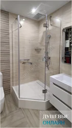 Photo of a bathtub with a shower screen without a tray