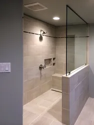 Photo of a bathtub with a shower screen without a tray