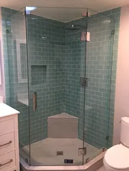 Photo of a bathtub with a shower screen without a tray