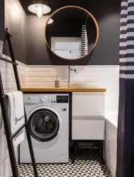 Black washing machine in the bathroom photo