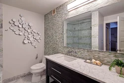 Bathtub with decorative plaster and tiles photo design