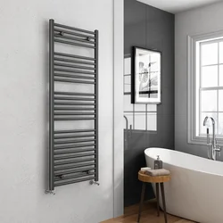 Black heated towel rail in the bathroom interior