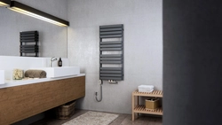 Black heated towel rail in the bathroom interior