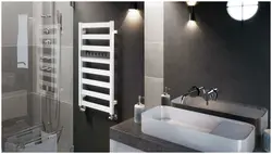 Black heated towel rail in the bathroom interior