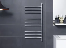 Black heated towel rail in the bathroom interior
