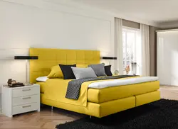 Yellow bed in the bedroom interior