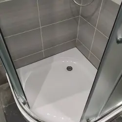 Photo of shower enclosures in the bathroom with a tray