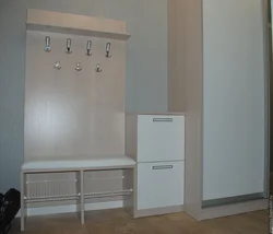 Narrow coat rack with shoe rack in the hallway photo
