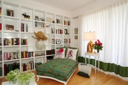 Books in the interior of the living room photo in a city apartment