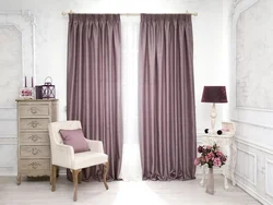 Pink curtains in a gray living room interior