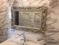 Mirror in a frame for the bathroom photo