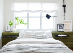 Bedroom interior with a window at the head