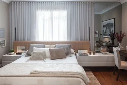 Bedroom interior with a window at the head