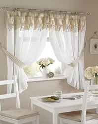 Curtains with flowers in the kitchen interior