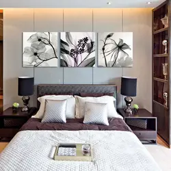 Photo of a bedroom with a flower above the bed