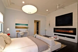 Bedroom with fireplace and TV photo