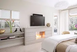 Bedroom with fireplace and TV photo