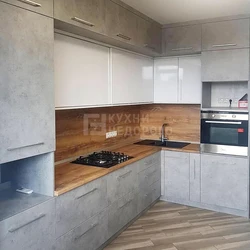 Concrete kitchen with wooden countertop in the interior