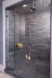 Photo of a bathroom with a shower behind glass