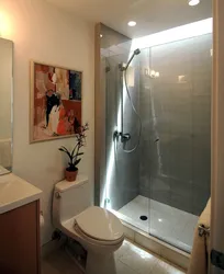 Photo of a bathroom with a shower behind glass