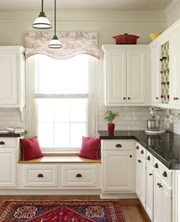 Kitchen design with a window in the middle and a radiator under the window