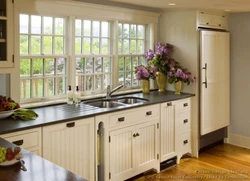 Kitchen design with a window in the middle and a radiator under the window