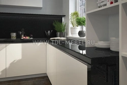 Countertops in the kitchen interior made of white gloss